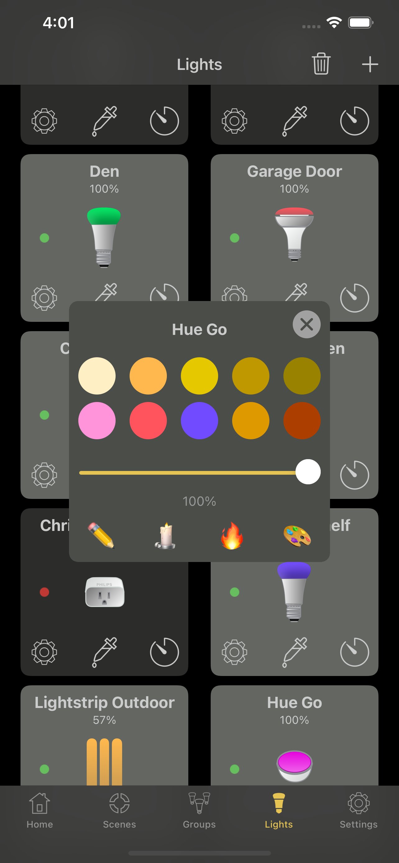 Hue Lights app showing the Lights view with bulbs for Den, Garage Door, Christmas, Lightstrip Outdoor and Hue Go, with a Hue Go color picker open displaying warm color presets.